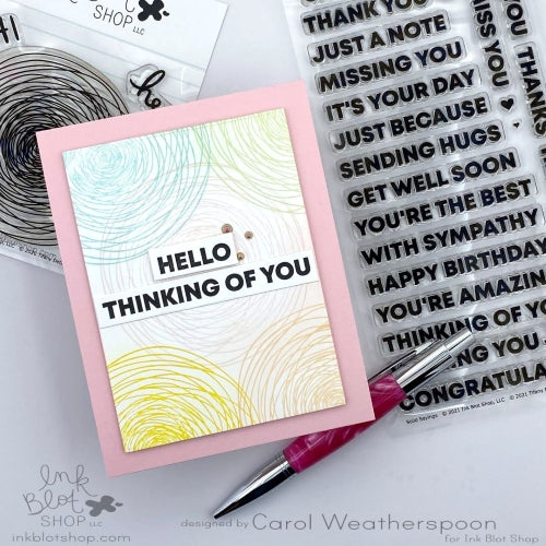 Card with 'Hello, Thinking of You' text on a white background with a pen and stamp set.