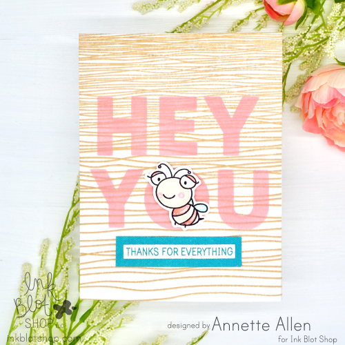 Stamped greeting card with 'Hey You' text and a cute cartoon bee, featuring craft supply products from Ink Blot Shop.